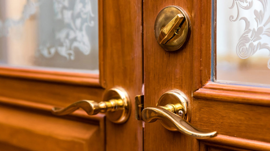 upclose view of gold handles on wooden doors