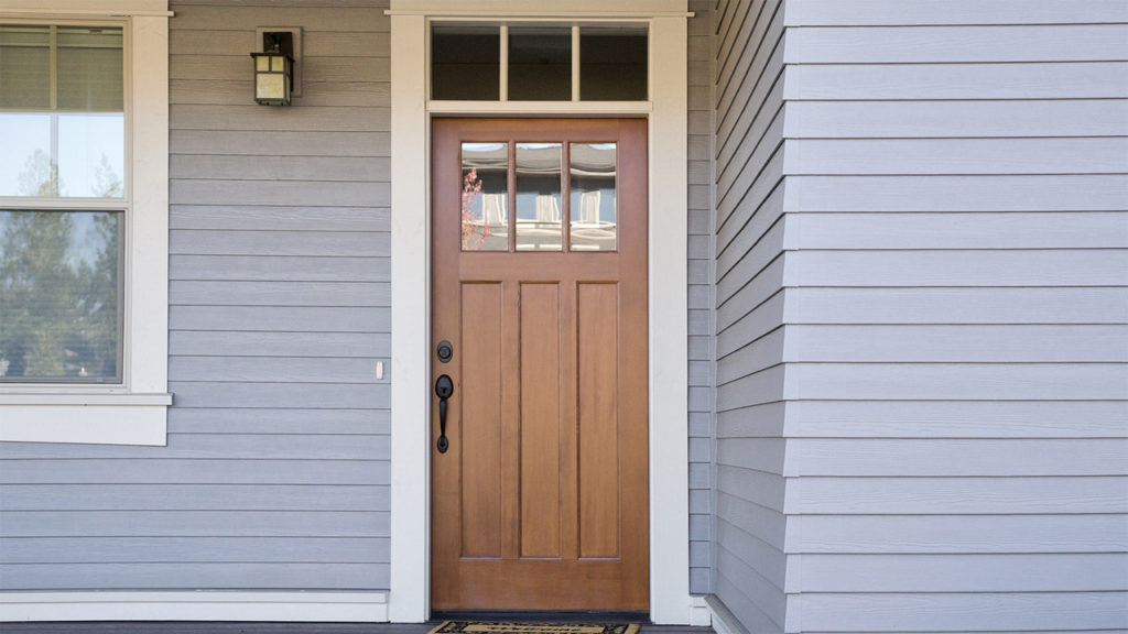 wooden door of gray home